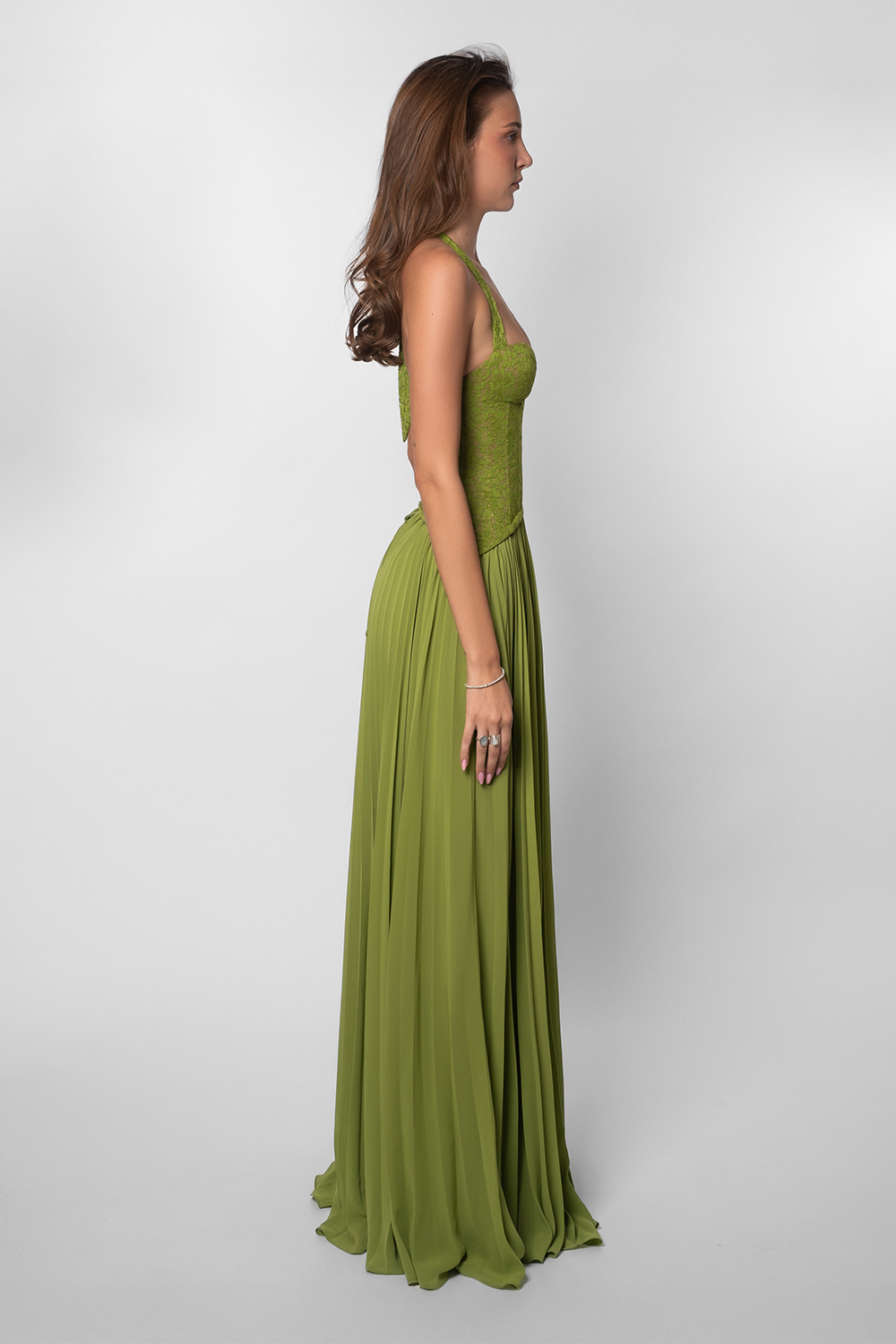 Side view of a model in a olive green maxi gown