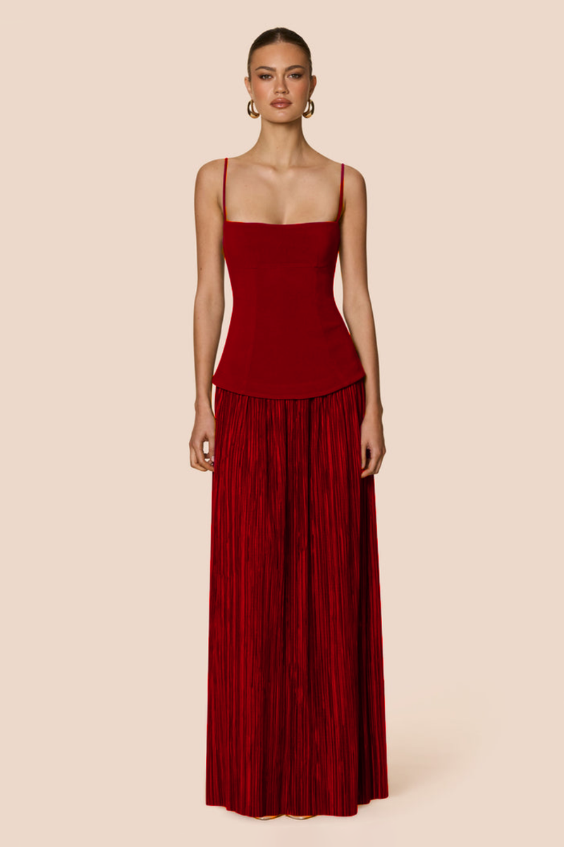 Red dress worn by a model on a beige background